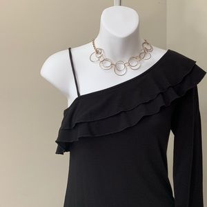 One shoulder, ruffled top with adjustable strap.